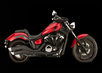 Red & black motorcycle in front of a black background.