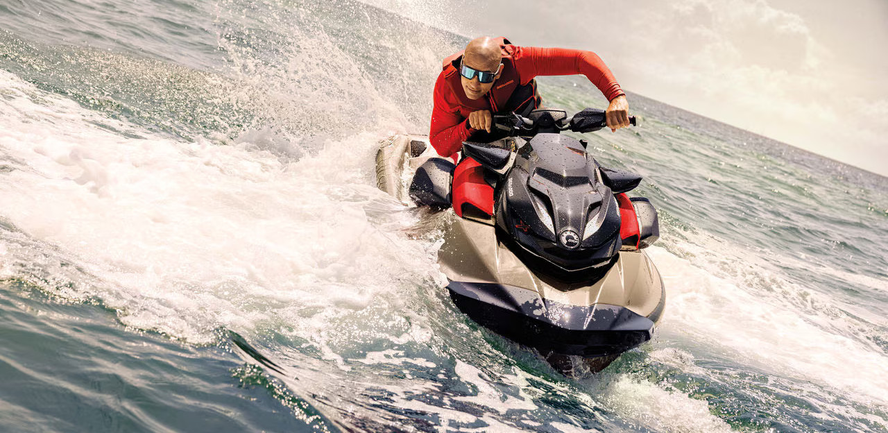 Image of a ban riding a gold Sea-Doo RXP-X 325 RS